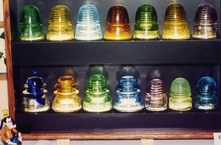 Close-up of Colorful Glass Insulators in Different Shapes and CDs